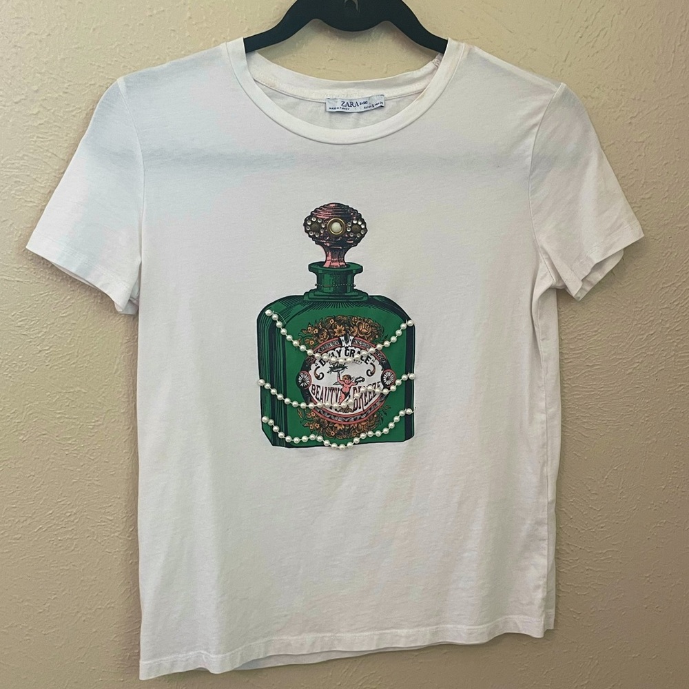 Zara T Shirt with perfume graphic and pearl embellishments